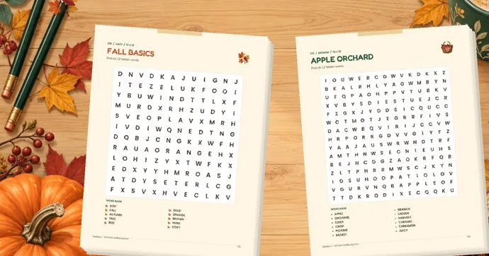 Two printed fall word searches, Fall Basics and Apple Orchard, on a wooden table with pencils, maple leaves and a pumpkin